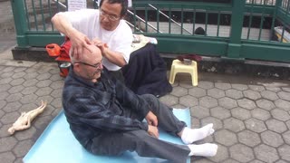 Luodong Massages White Man On Sidewalk