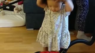 Baby girl figure out vacuum cleaner for the first time