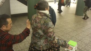 Luodong Massages Older Woman In Subway Station