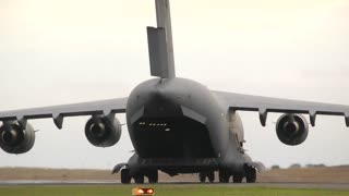 C-17 and B-52 hover above us