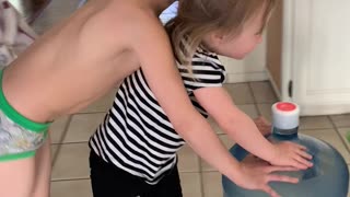 Siblings don't spill any water... girl takes the spill.