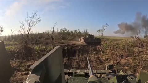 A trio of Ukrainian M2A2 Bradley IFVs move under fire outside of Robotyne.