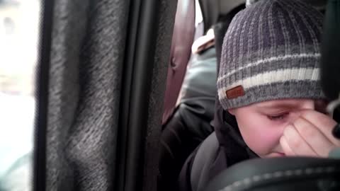 'We left our Dad in Kyiv' -little boy chokes back tears