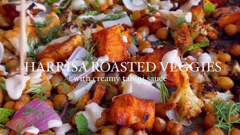 "Fireside Feasting: Spice Up Your Meal with Harissa Roasted Veggies, Chickpeas, and Creamy Tahini Sauce!"