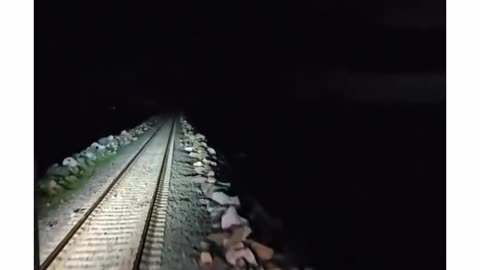 A train ride over the dark sea in a storm