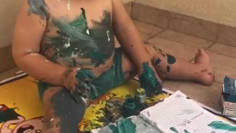 Artistic toddler makes a gigantic mess with watercolors