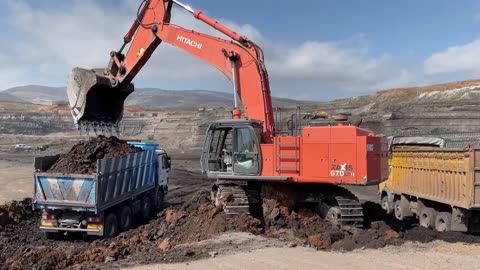 Hitachi Zaxis 670LC Excavator Loading Mercedes And MAN Trucks - Operator Anogiatis