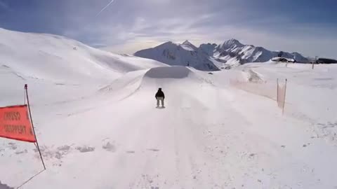 Guy follows his friend as he takes on huge ski jump. Friend fails