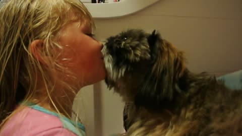 My little lady is kissing Jackson the dog