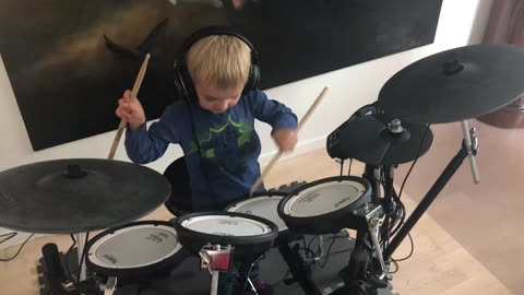 Small Boy playing the drums