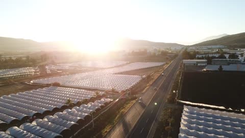 Aerial view of a road between greenhouses