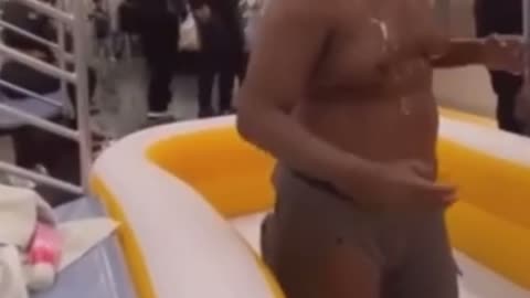 Man in inflatable pool in NYC subway