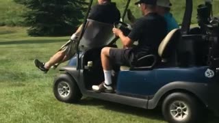 Golfer black shirt hit by golf cart breaks windshield angle 2