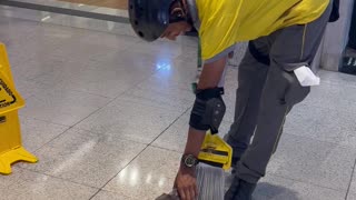 Puppy Plays With Mop at Shopping Mall