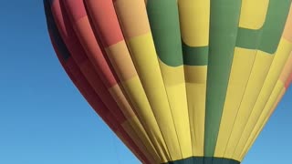 Hot Air Balloon Hovers Over Cars