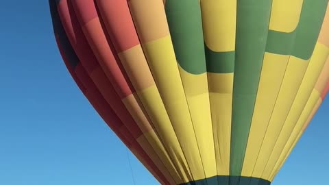 Hot Air Balloon Hovers Over Cars