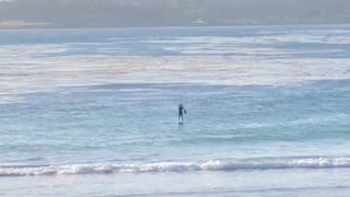 Man in distance paddle boarding