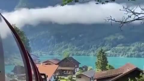 Curling train amidst clouds and Mountains.