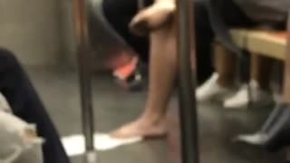 Barefoot man with dirty feet on subway