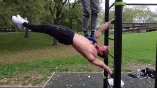 Man shows off insane strength while demonstrating the "human flag"