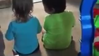 Little girl preciously consoles her twin brother