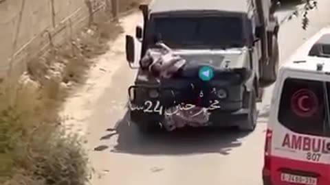 Demonic Israeli terrorists strap an unarmed Palestinian civilian to the hood