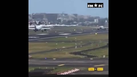 Plane lands on runway as another jet takes off at same time