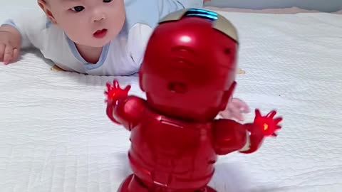 Cute baby playing with robot toys.😲😲