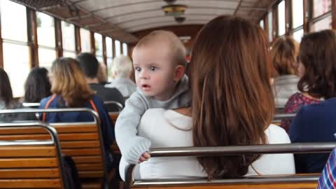 Baby enjoying his first train ride With his parents