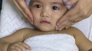 This baby is absolutely loving her facial massage