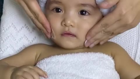 This baby is absolutely loving her facial massage