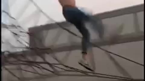 Shirtless jeans jump off black rope fail