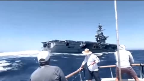 Reeling In The "Big One" When The USS Teddy Roosevelt Sails By