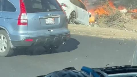 White Tesla Car burning up in flames from a minor accident