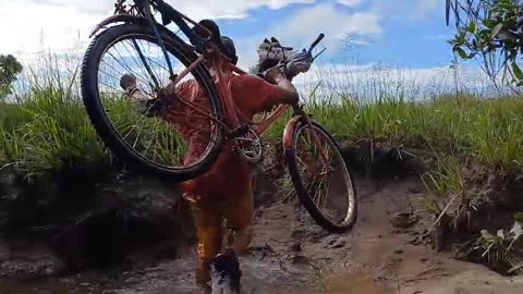 Guyana: Frontline Missions Hewlete David takes bike and motorcycle across river on mission trip.