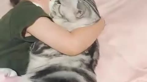 Cat Enjoying Sleeping With Little Girll