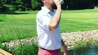 Red shorts guy hits golf ball off wooden bridge drinks been and jumps into water