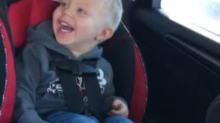 Cute kid laughs at elephant sounds