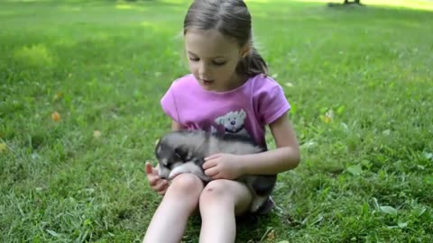 Adorable little girl sings lullabies to her pup