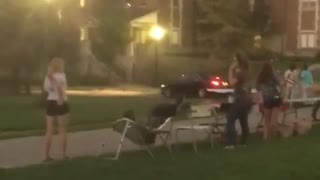 Guy in brown vest drinks beer and then runs on table
