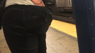 Woman pulls out wedgie and digs in pants at subway station