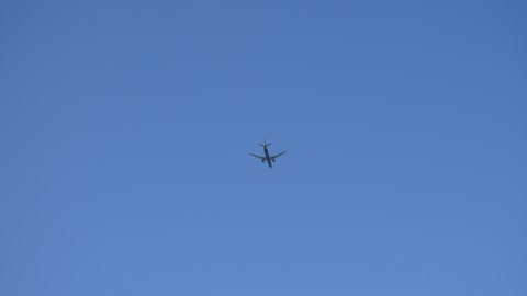 Plane in the blue sky from takeoff