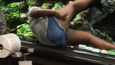 Woman Bathes in Produce at Supermarket