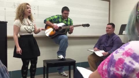 music teacher singing 'Love Yourself' by Justin Bieber during class