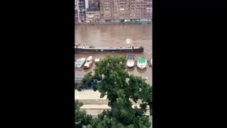 Watch as a barge sinks in a flooded Belgian river