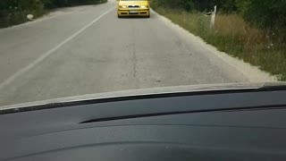Crazy driver drives backwards down road