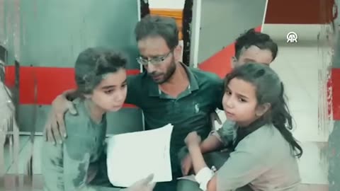 GAZA - Palestinian father comforts his crying