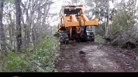 Bulldozers cut a road through the mountain