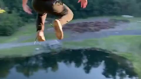 Brave guy jumps off a cliff into water