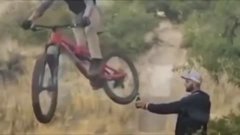 Man opening Bud Light beer bottle with bicycle.